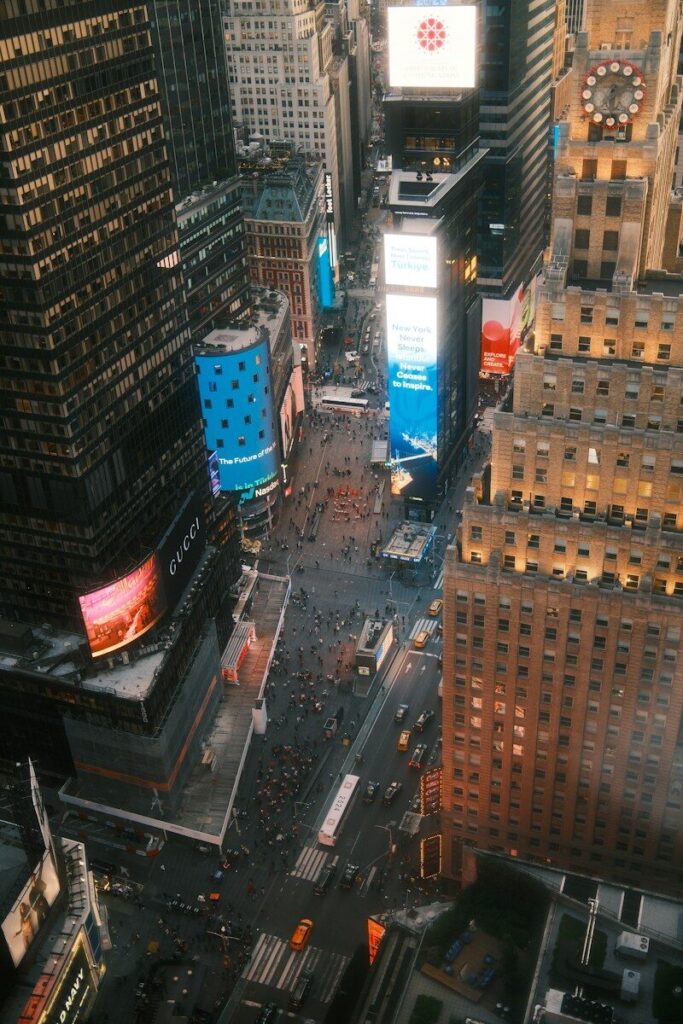 Aerial view of Times Square in New York City with illuminated billboards and pedestrians